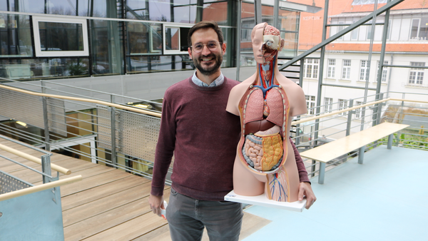 A professor with the corpus in the university building