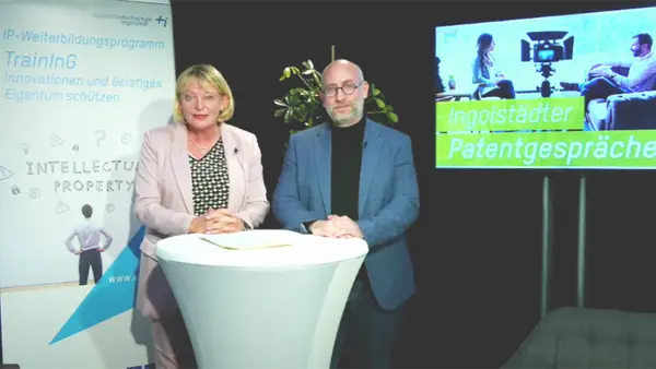 Two presenters at the bar table during the live broadcast