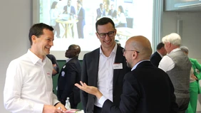 Three men are talking and laughing.