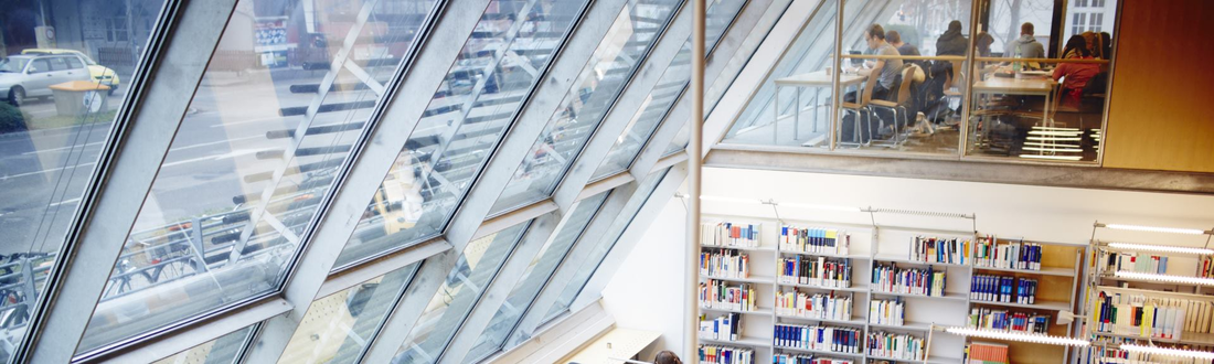 View of the library with glass front, workstations and bookshelves