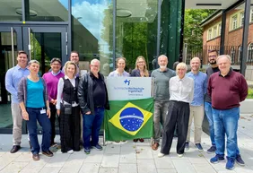 Gruppenbild der Gastfamilien am Campus in Neuburg mit einer Brasilien-Flagge